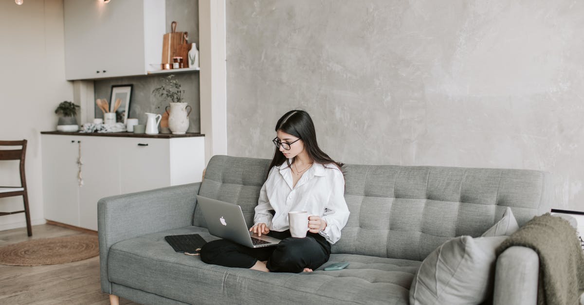 Signing digital Family information form for Canadian Visa - Woman Sitting On Sofa While Working At Home