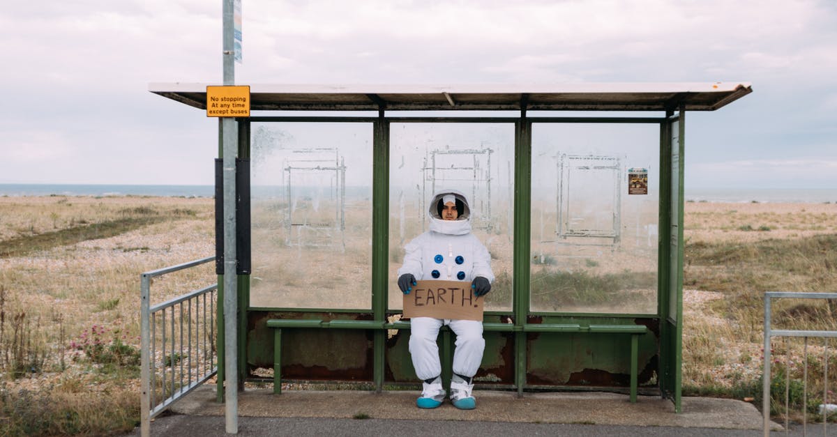 Signs for hitchhiking in Israel - Astronaut Waiting At A Bus Stop