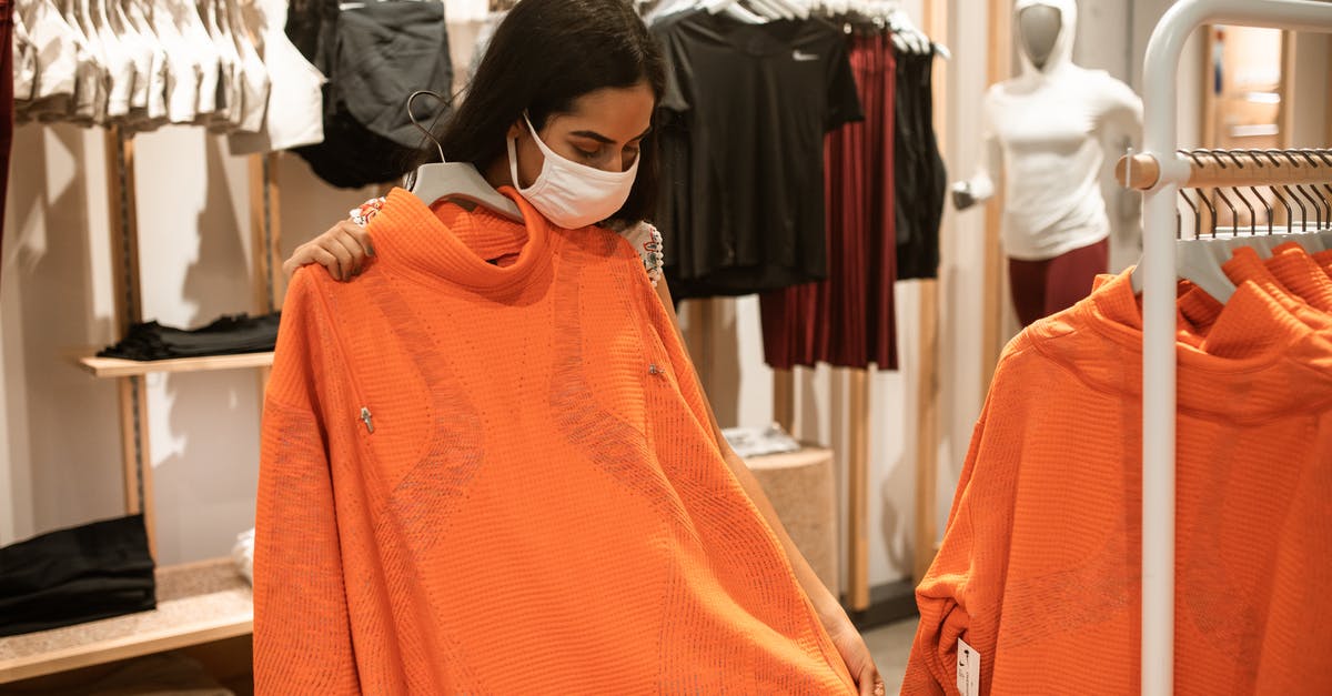 Simpler stop-over option - Woman Checking On An Orange Shirt Inside A Department Store