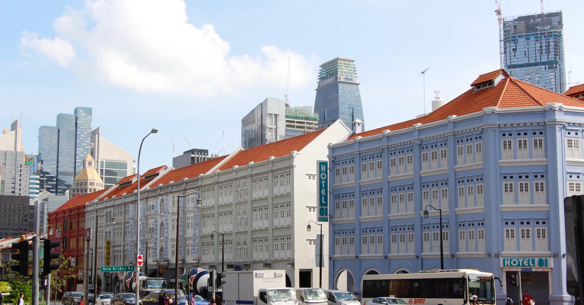 Singapore visa - duration of stay - A Moving Cars on the Road Near the City Buildings