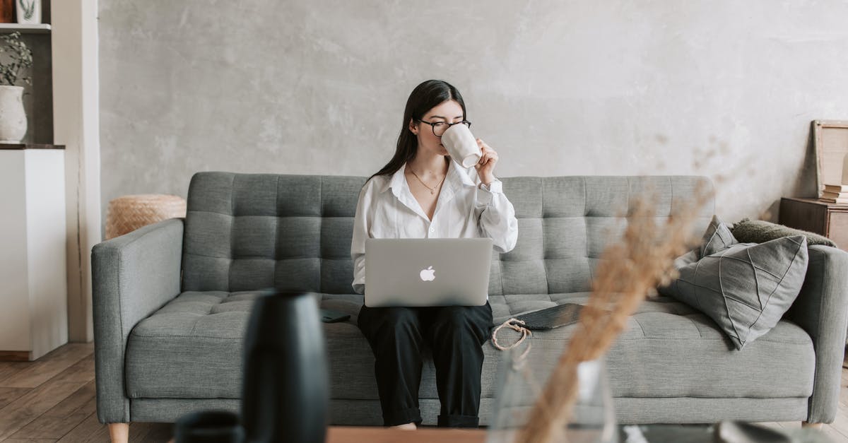 Singapore Visa for a freelance Software Engineer - Woman Drinking Coffee While Working With Laptop