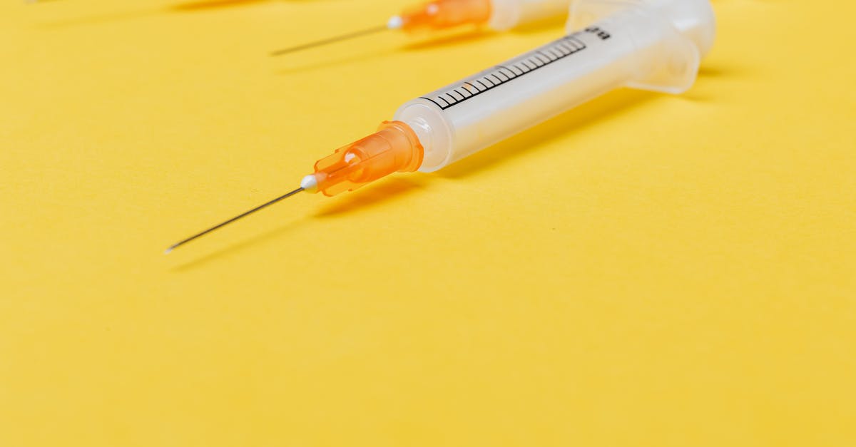 Single entry visa with stop-over - Medical single use disposable syringe without protective cover on needle and with empty barrel placed on bright yellow surface