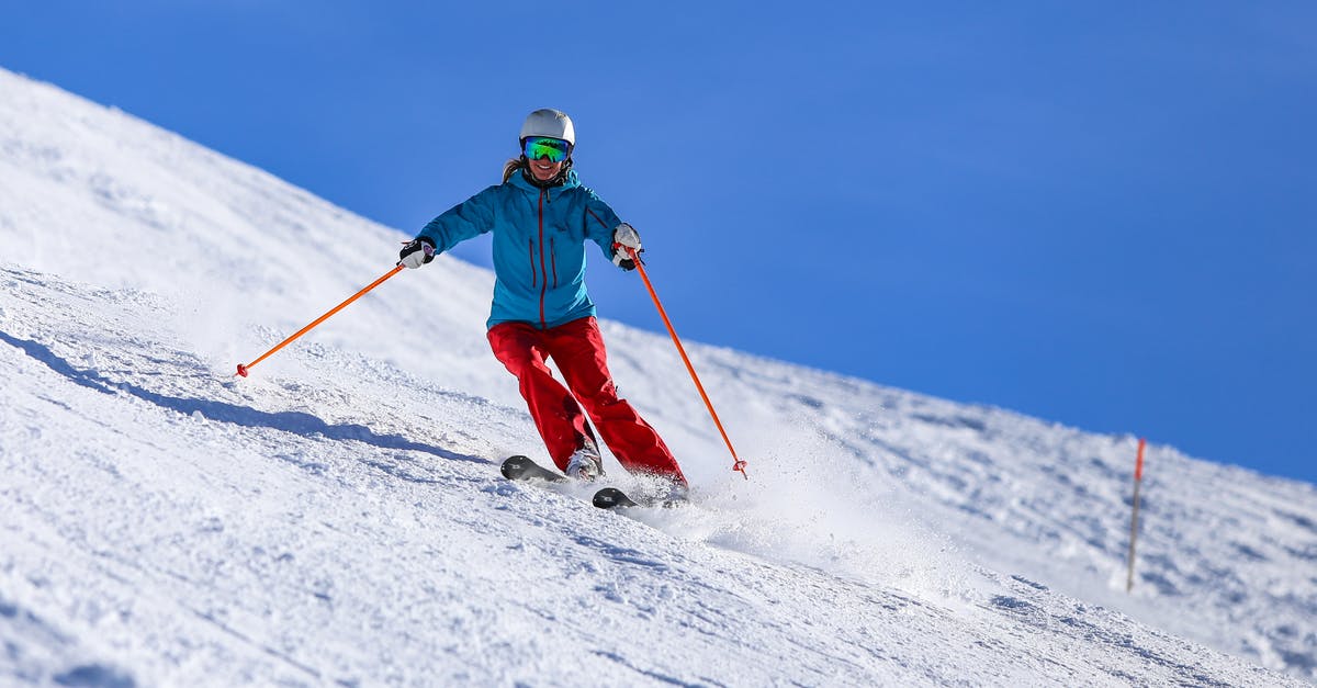 Skiing near Bangalore? - Person in Blue Jacket and Red Pants Riding on Snow Ski