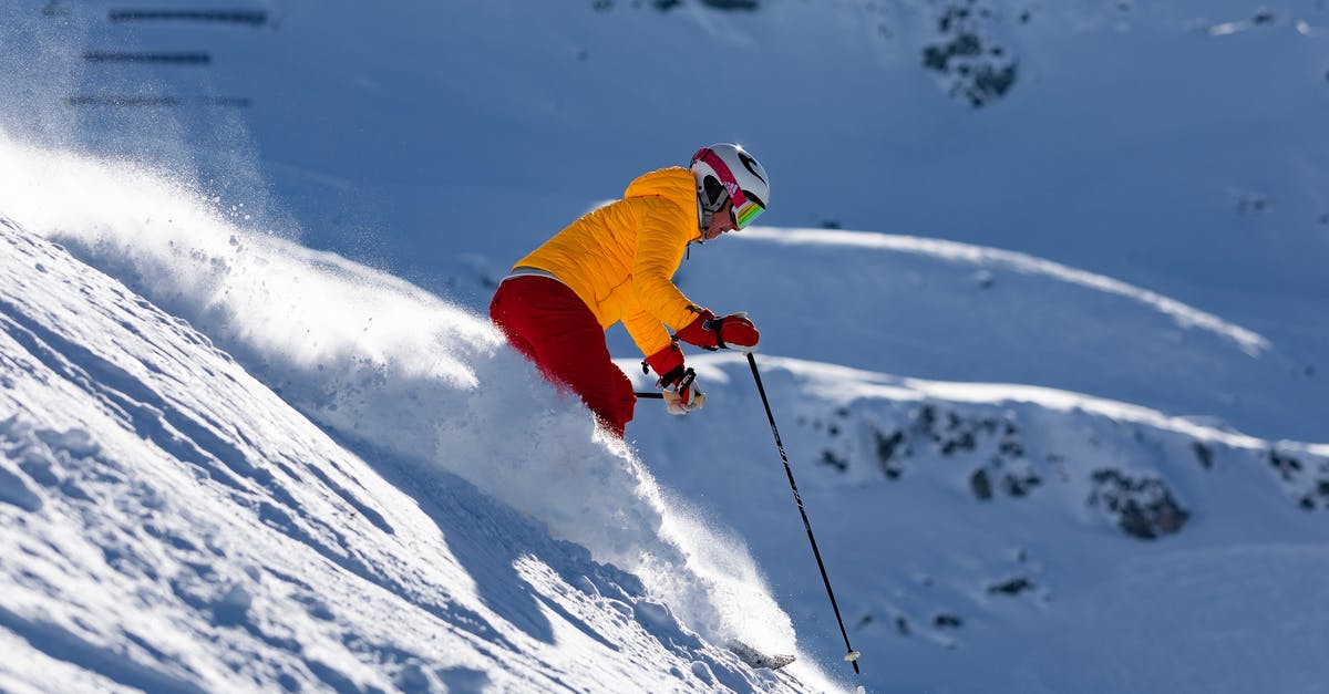 Skiing near Frankfurt 18-23 February - Person in Red Jacket and Blue Pants Riding on Ski Blades on Snow Covered Mountain during