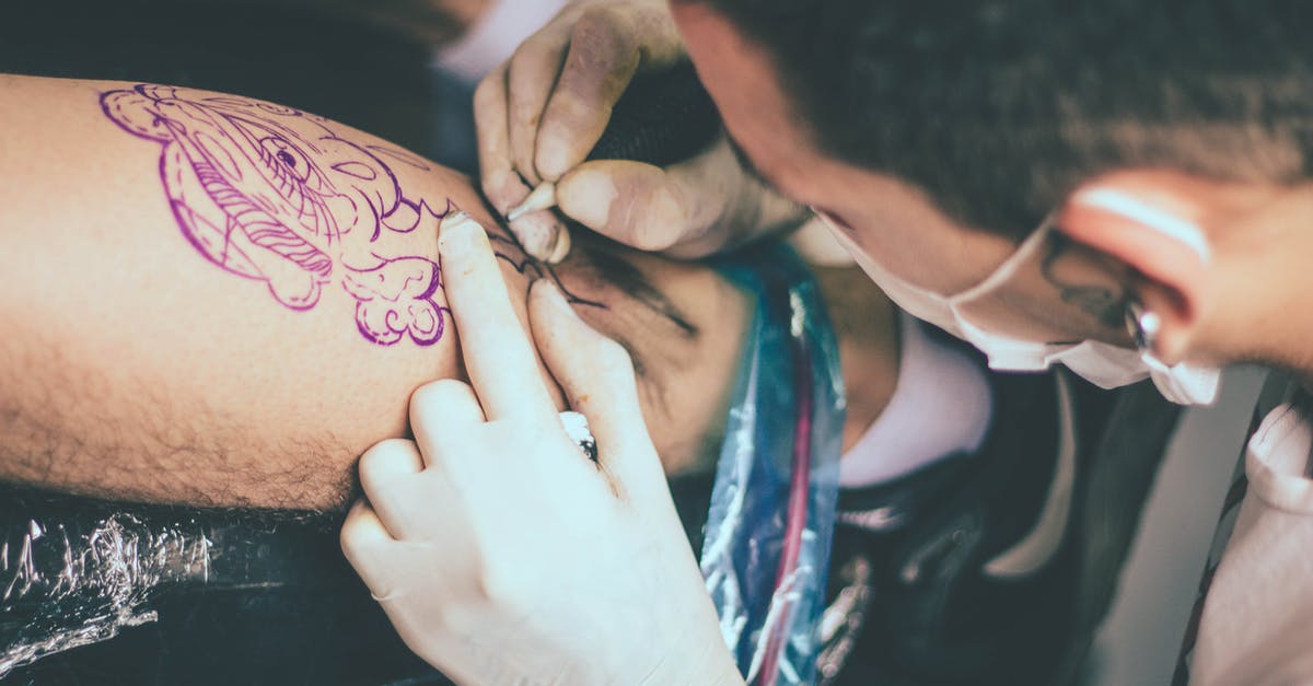 Skipping second leg when transferring in Vienna - Close up of a Man Tattooing Mans Leg