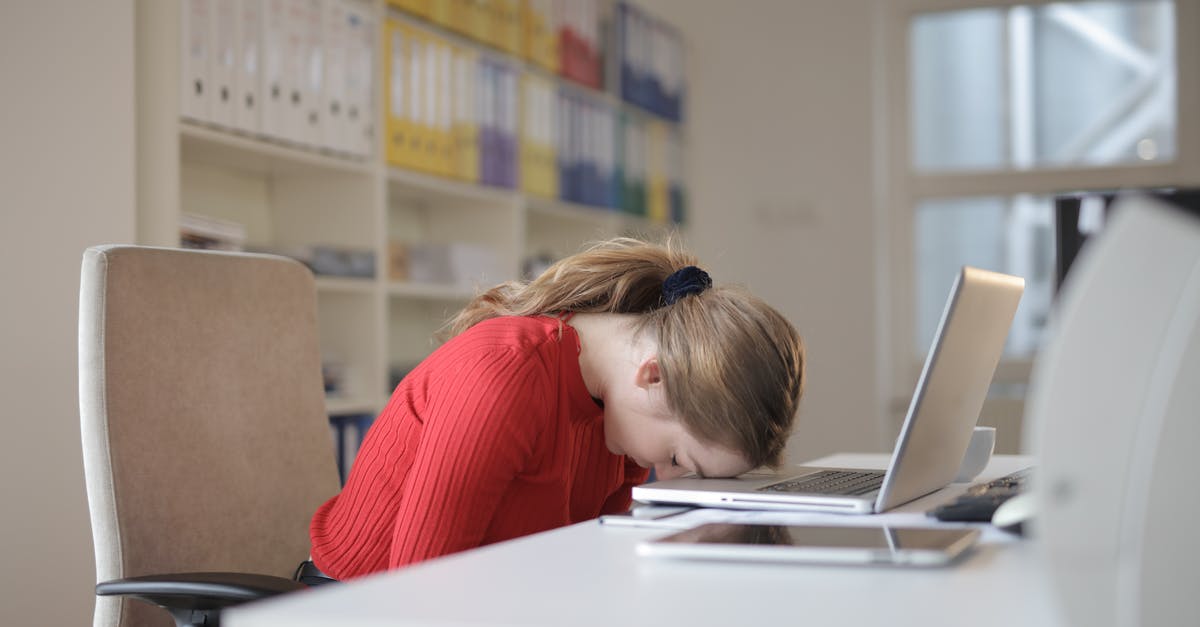 Sleep sitting upright [duplicate] - Woman Sitting on Chair While Leaning on Laptop