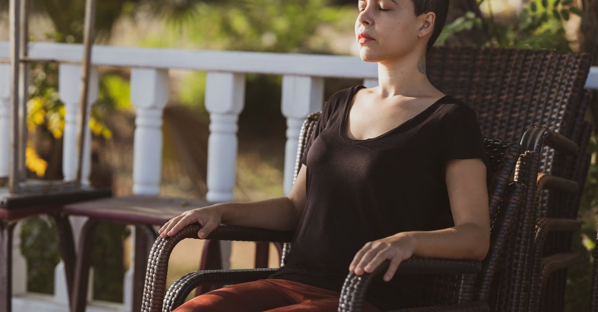 Sleep sitting upright [duplicate] - Woman in Black Top Sitting on Brown Armchair