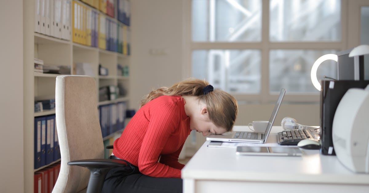 Sleep sitting upright [duplicate] - Woman in Red Long Sleeve Shirt Sitting on Chair While Leaning on Laptop