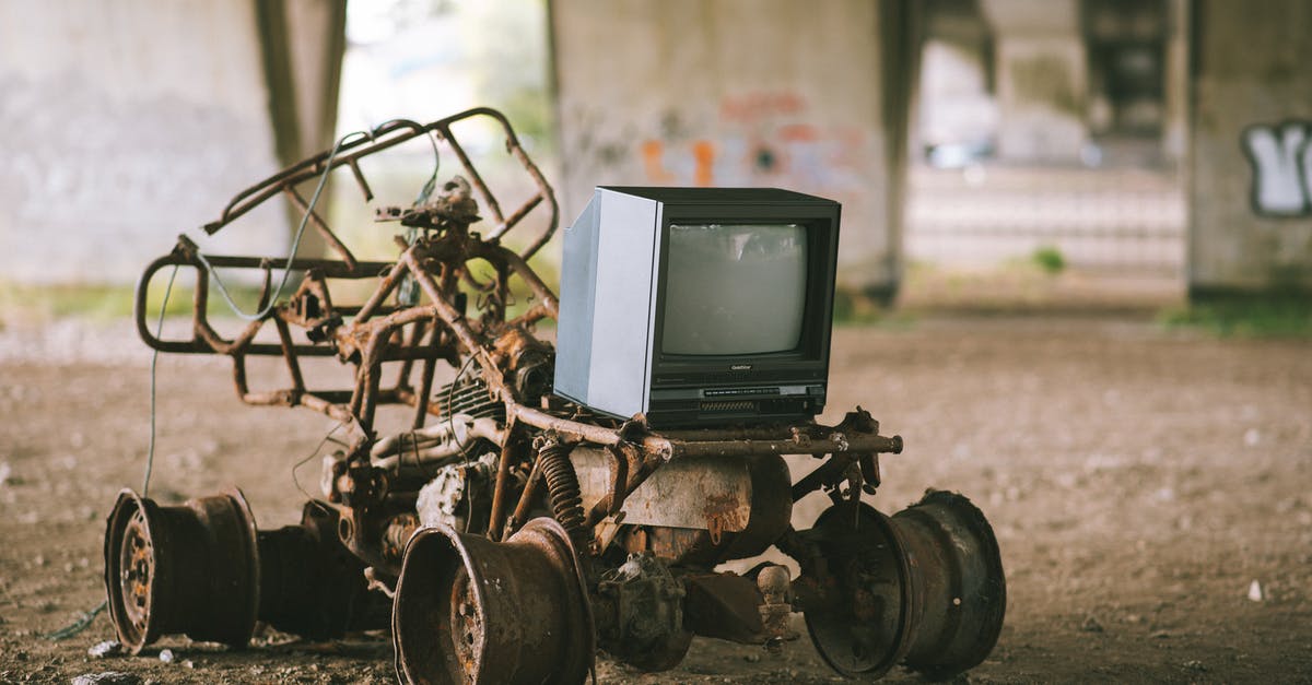 Small historical stone bridge in the North of Seoul - Small black old fashioned television placed on rusty metal construction under stone bridge with graffiti on blurred background in street