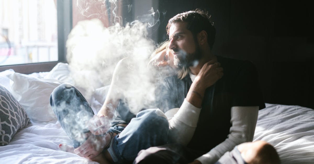 Smoking weed in Amsterdam as a tourist - Man in Black Long Sleeve Shirt Smoking Cigarette