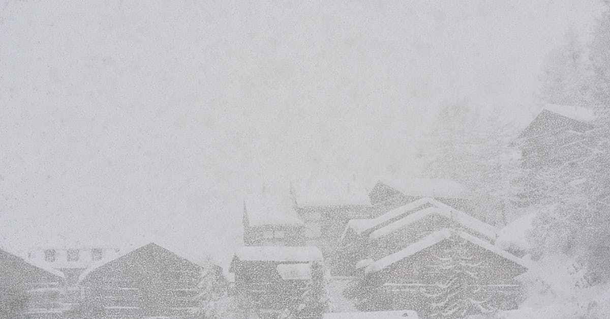 Snow Access in North India in the winter - Severe scenery of remote rural village houses covered with thick layer of snow during intense snowstorm on cold winter day