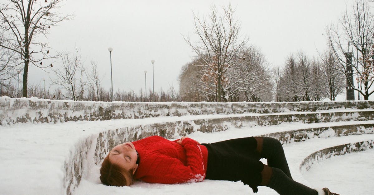 Snow fall this Christmas near Hong Kong? - Woman Wearing Red Sweater Lying on Snow Covered Ground