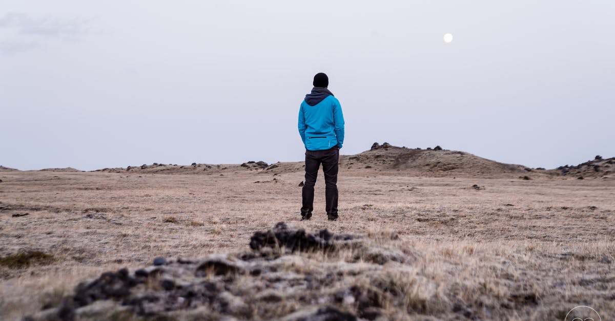 Solo travelling EU at 17 - Man in Blue Hoodie Standing on Brown Grass