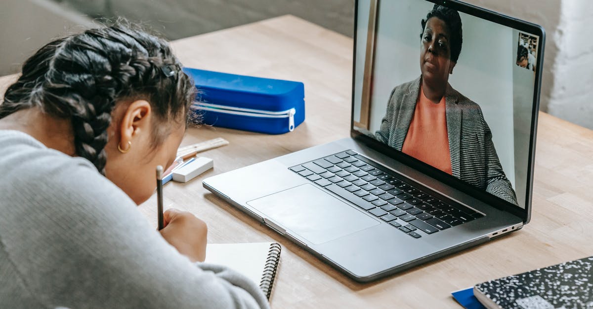 Some question about select-pass from Eurail - From above of clever diligent ethnic girl writing homework in notebook while listening to teacher online on laptop