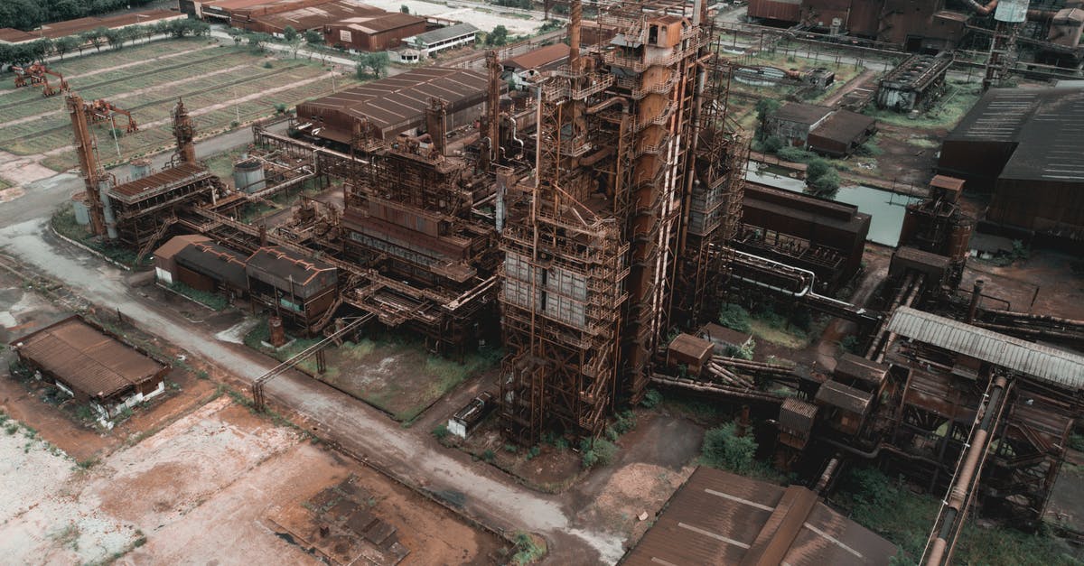 Sources for infrastructure damage due to heavy rains in Peru? - Drone view of aged abandoned industrial factory with rusty metal constructions in suburbs