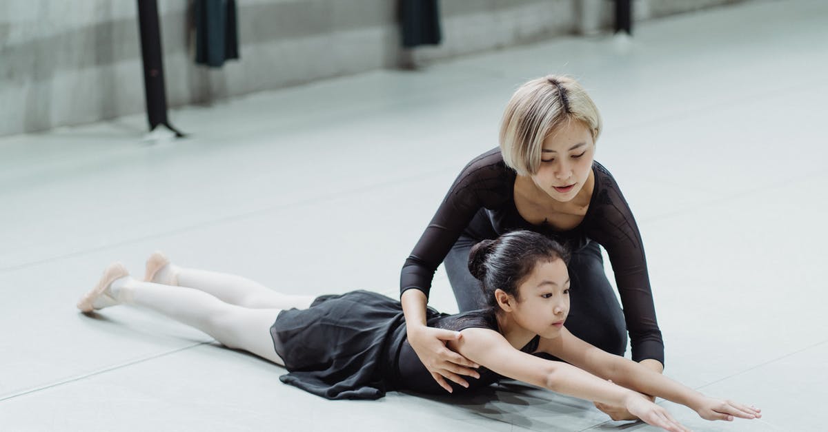 Southwest Airlines - Extend Layover? - Young professional Asian ballerina training in studio with adorable little beginner girl