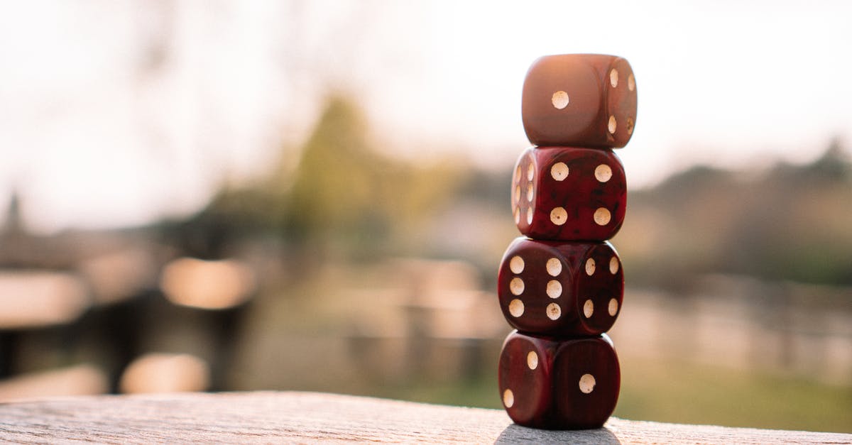 South-west US/Hawaii Volleyball fun tournament in September - Set of red dice stacked together on wooden table placed on sunny terrace in daylight