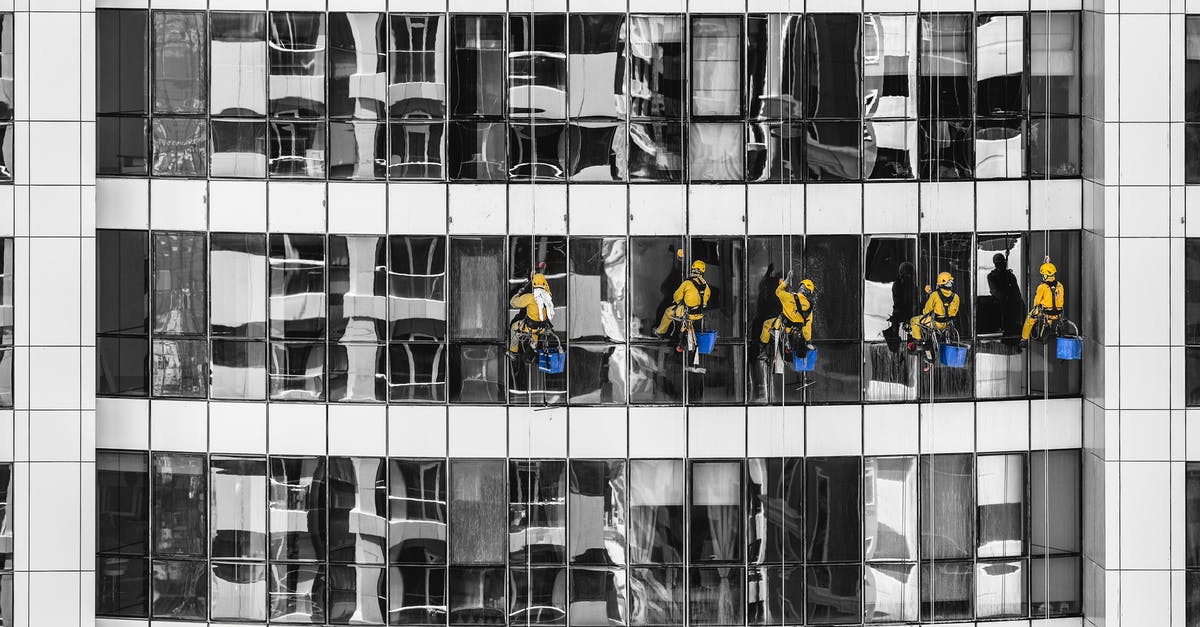 Square donuts in Dubai - Five Person Cleaning Glass Building