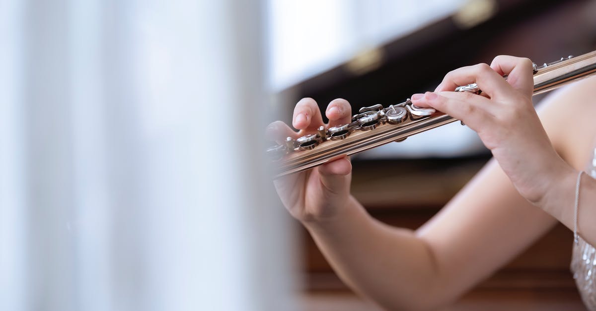 Standards of dress for a classical concert in the Czech Republic - Woman playing flute in concert hall