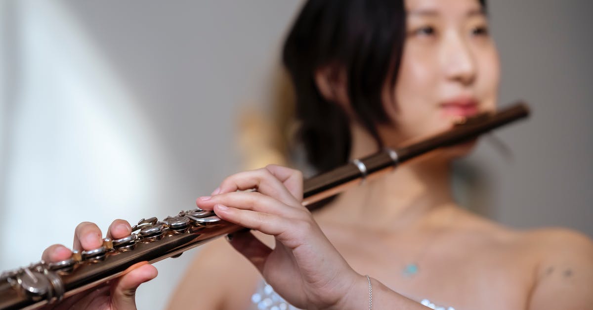 Standards of dress for a classical concert in the Czech Republic - Asian woman playing flute at concert