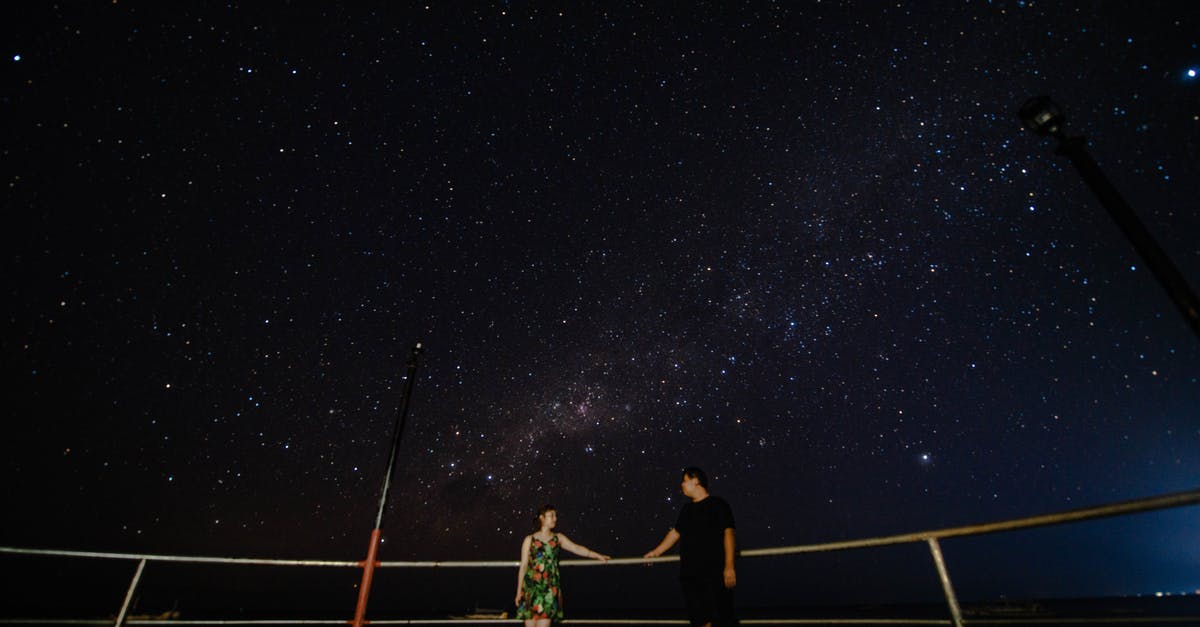 Star Alliance programme with free expiry date extension - Couple on viewpoint near railing under starry sky at night