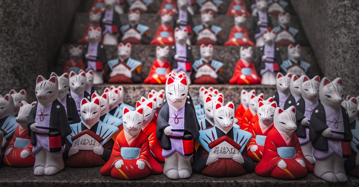 Stay in Osaka, Kyoto or both [closed] - Small Fox Statues at the Fushimi Inari Taisha Shrine in Kyoto, Japan