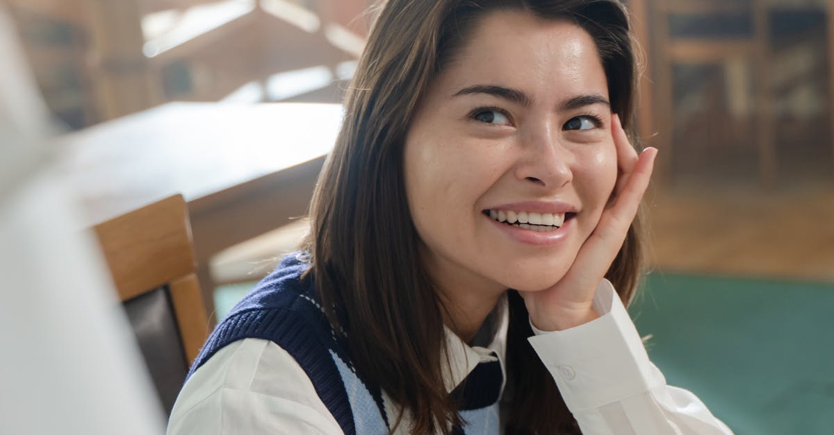 Staying in Belgium as a Student [closed] - Woman in Blue and White Long Sleeve Shirt Smiling