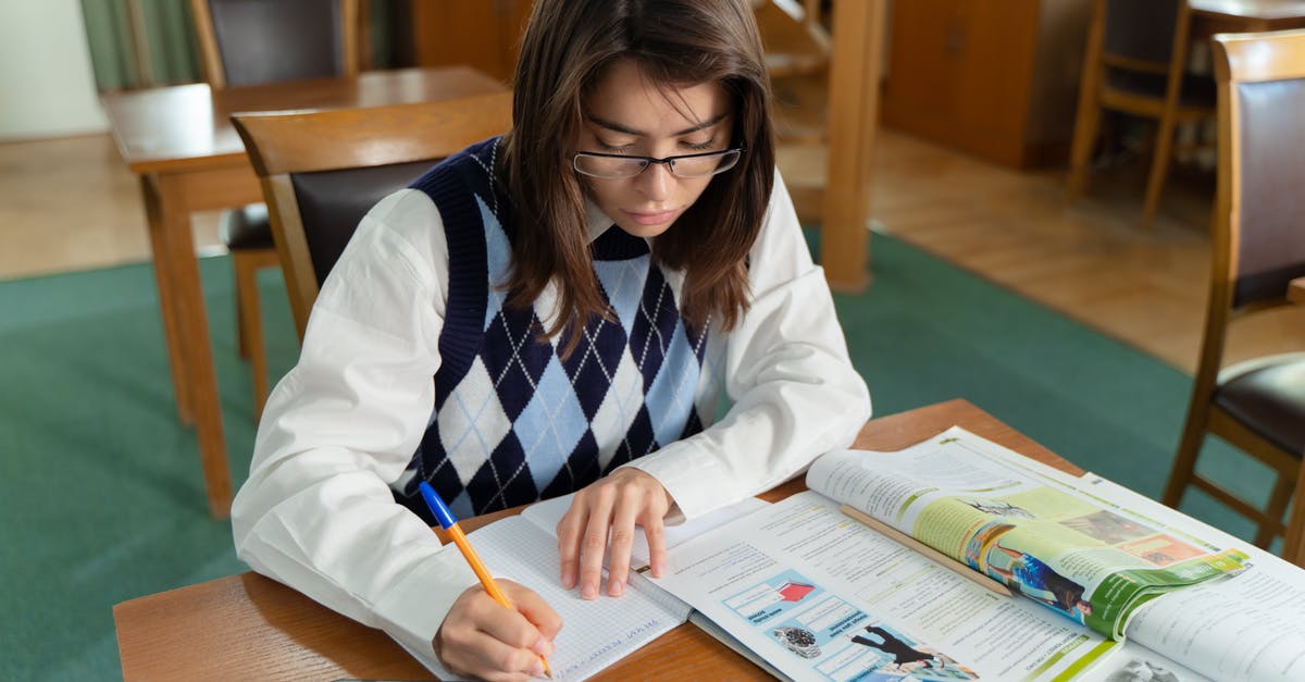 Staying in Belgium as a Student [closed] - Close-Up Shot of a Girl Studying in the Library