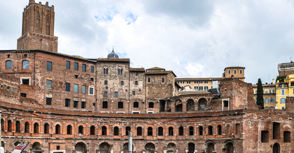 Staying longer in Italy - Brown Concrete Building Under Cloudy Sky