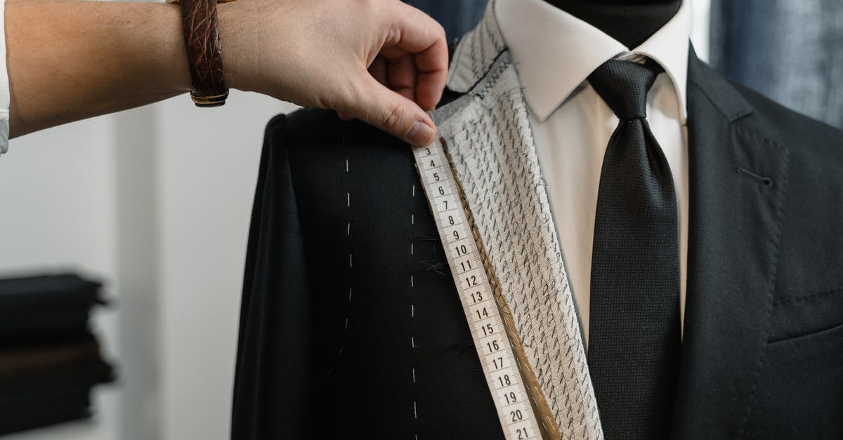 Stitching two Confirmation Numbers on United - Man in Black Suit Jacket Holding Brown Necktie