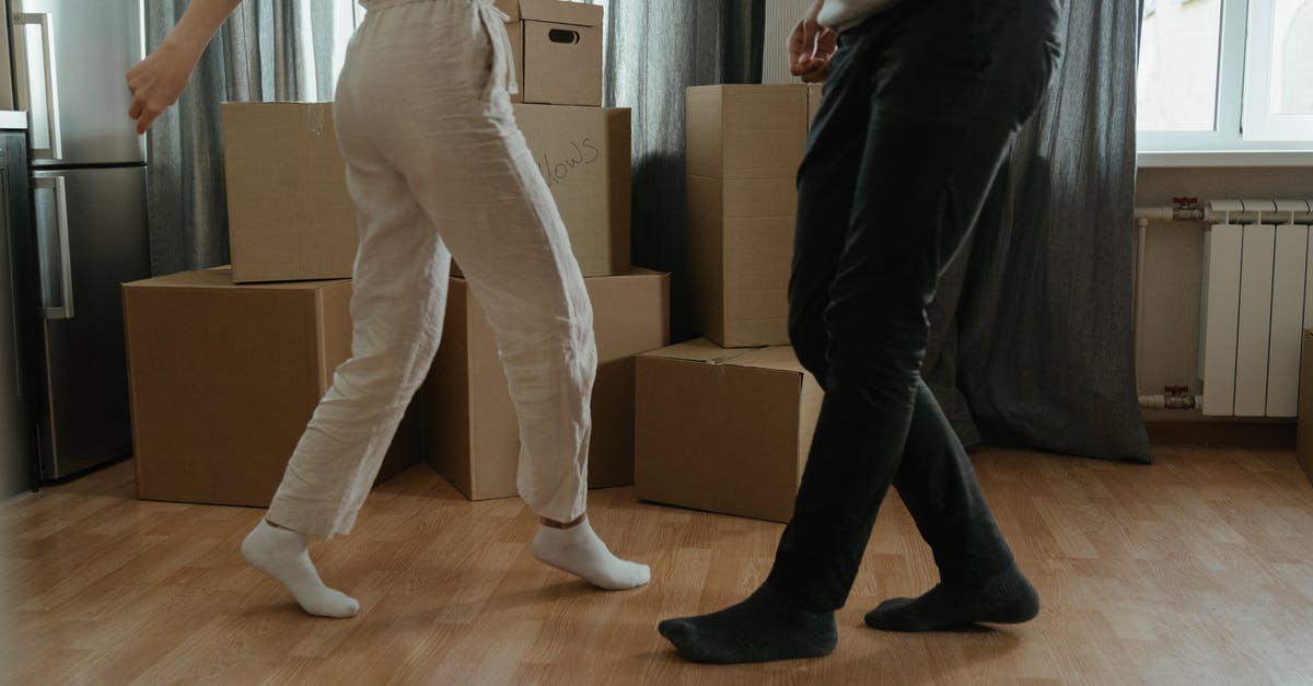 Storage that ships belongings to location [closed] - Man in White T-shirt and Black Pants Holding Woman in White T-shirt