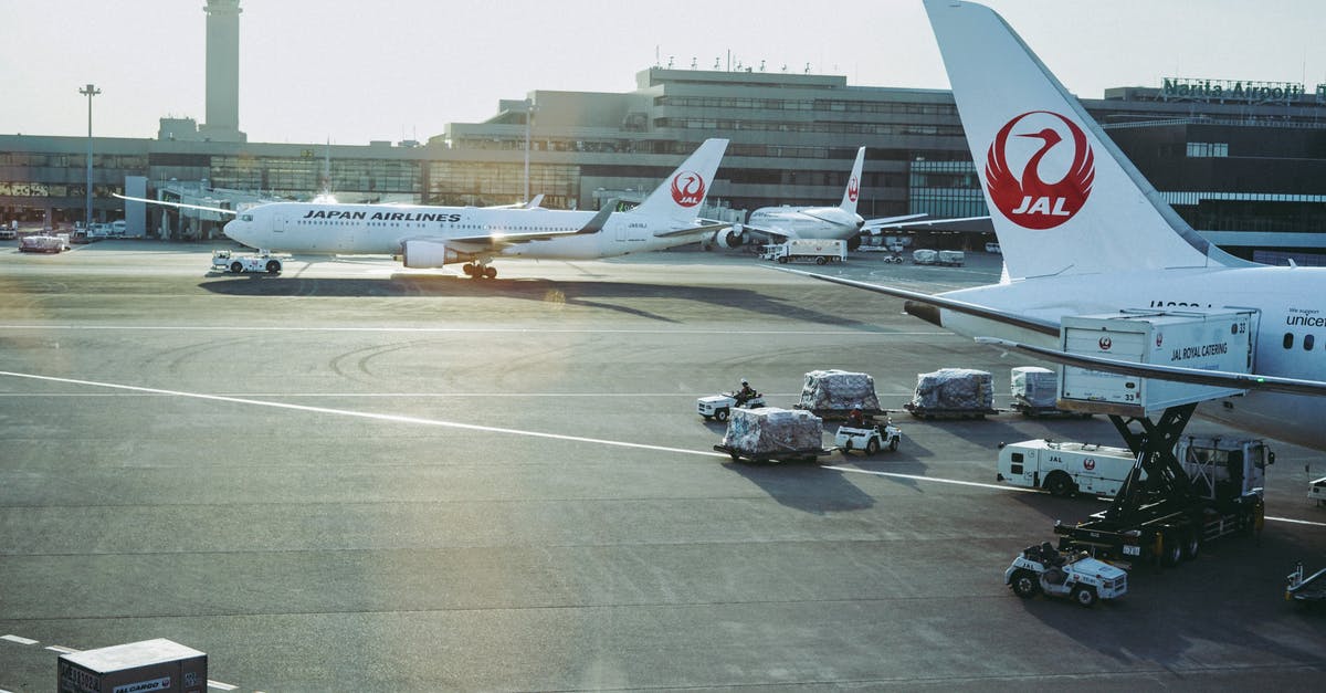 Storing luggage at Tokyo Narita Airport - Japan airlines filling a gas at Narita Airport