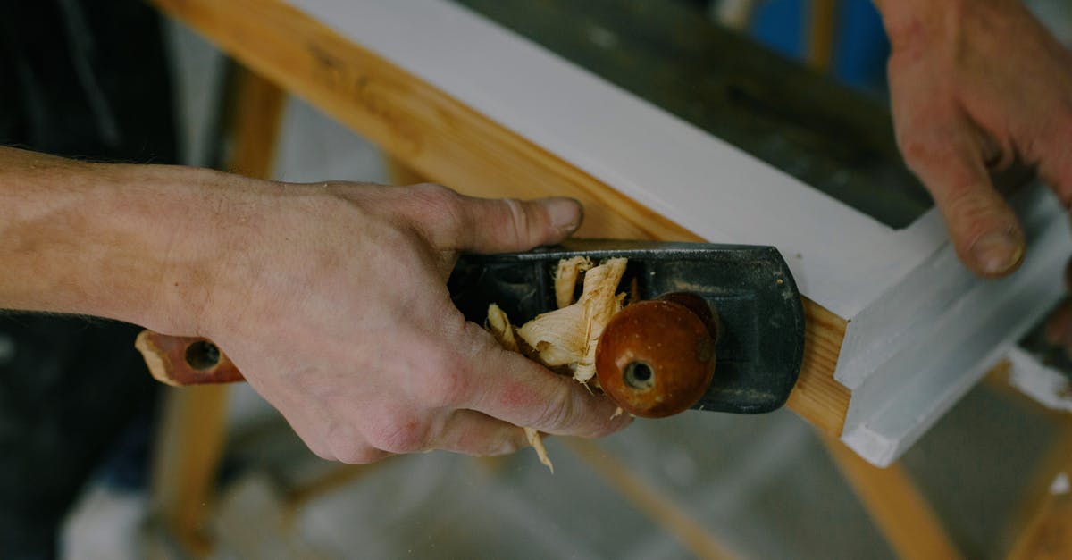 Strange knob on airplanes? - Crop carpenter working with window frame using plane