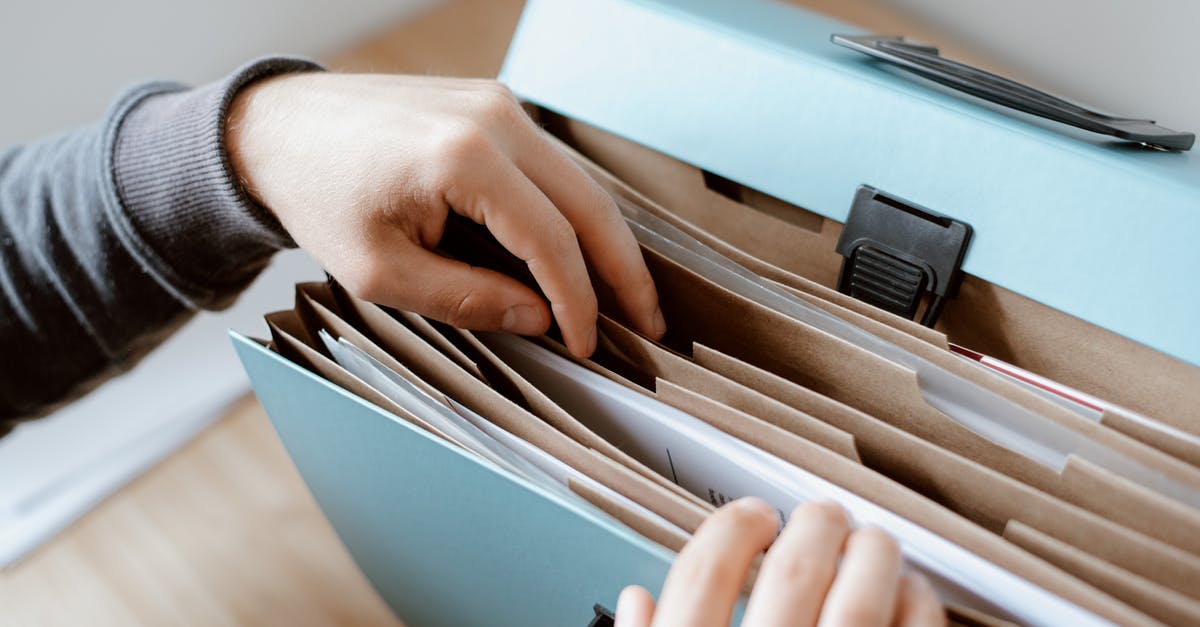 student discounts with student ID made from paper - Person choosing document in folder