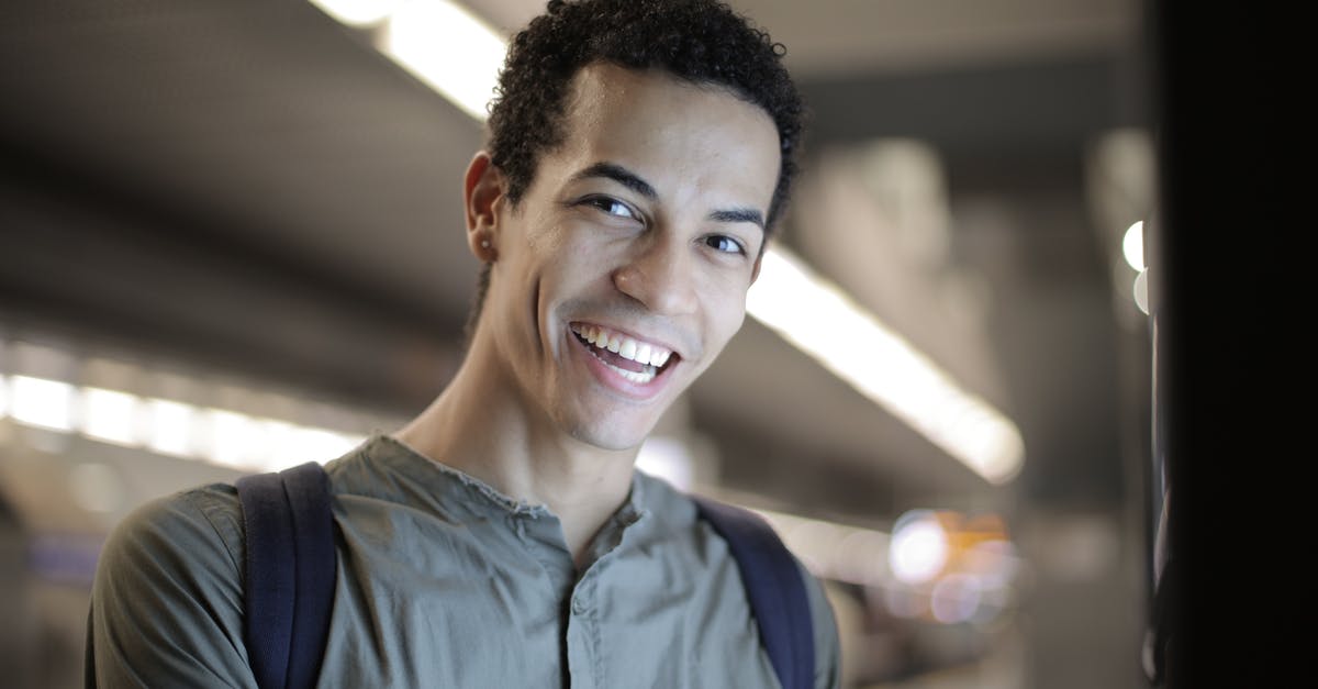 Student Visa come as a tourist before it expires - Cheerful ethnic woman in hallway of modern building