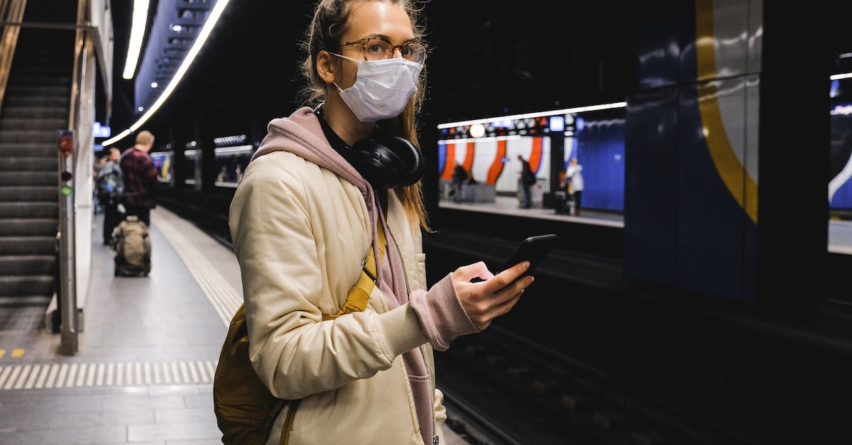 Subway, train or both when travelling around Tokyo - Woman With a Face Mask Standing on Train Station