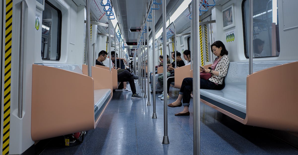 Subway, train or both when travelling around Tokyo - People Sitting on Train Seats While in Transit