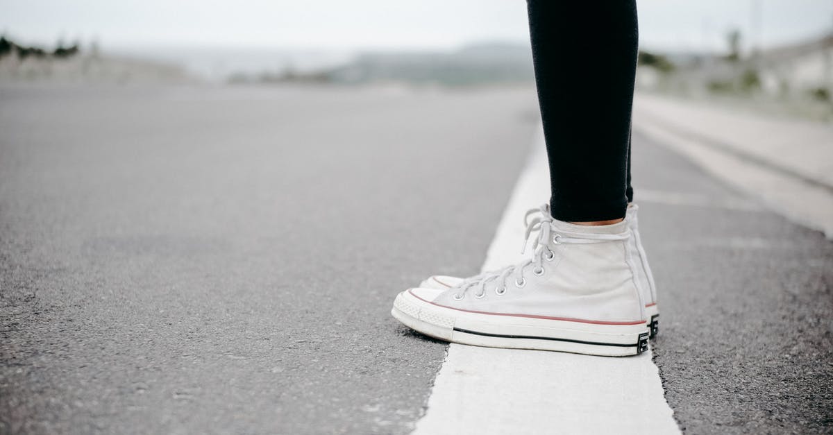 Suitable shoes for long-term, light-packing travel [closed] - Person Wearing White High-top Lace-up Sneakers Standing on White Line