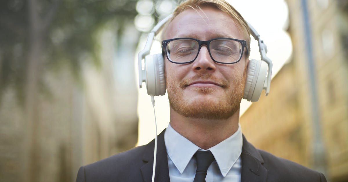 Supplies and support on a long-distance walk - Cheerful man in formal wear enjoying music