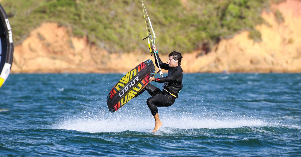 Surfing in Sri Lanka in August - A Man in Black Wetsuit Surfing on the Beach