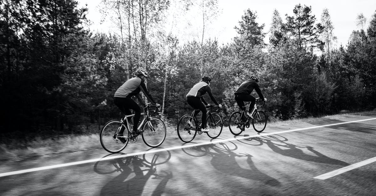 Swedish train operators that allow assembled bikes - A Grayscale Photo of Men Riding Bicycles on the Road