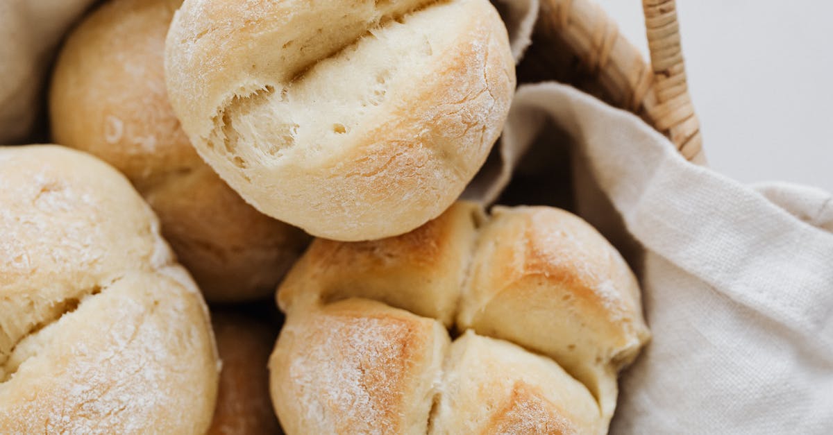 Swiss visa from London [closed] - From above closeup of freshly baked delicious buns with cross cuts on top lying on linen towel in wicker bowl