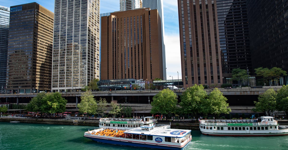 Take a nap in the United Club in Chicago O'Hare? - White and Blue Boat on Body of Water Near High Rise Buildings