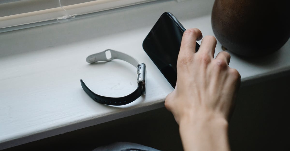 Take groceries in checked luggage - Person with smartphone and wristwatch in bedroom