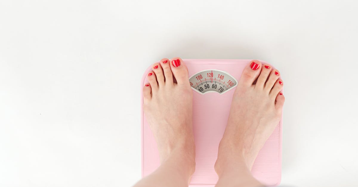Take test or obtain result 72 hours before arrival? (Flying to Lithuania) - Top view of crop anonymous barefoot female measuring weight on scales on white background Take test or obtain result 72 hours before arrival? (Flying to Lithuania) - Top view of crop anonymous barefoot female measuring weight on scales on white background