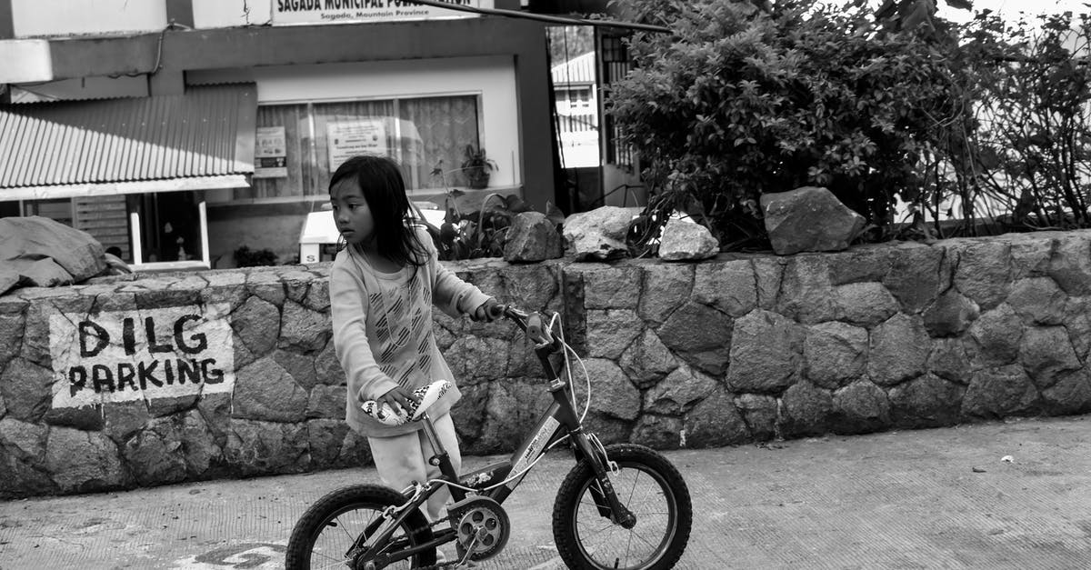 Taking a non-foldable bike from Paddington station in London, UK - Grayscale Photo of Girl Holding Bike