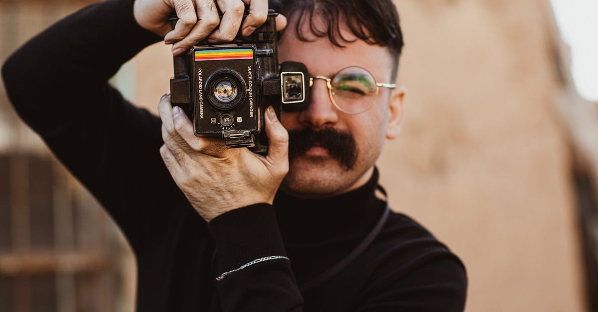 Taking a photo in a US supermarket - Male Photographer with Big Mustache Taking Photo with Vintage Camera