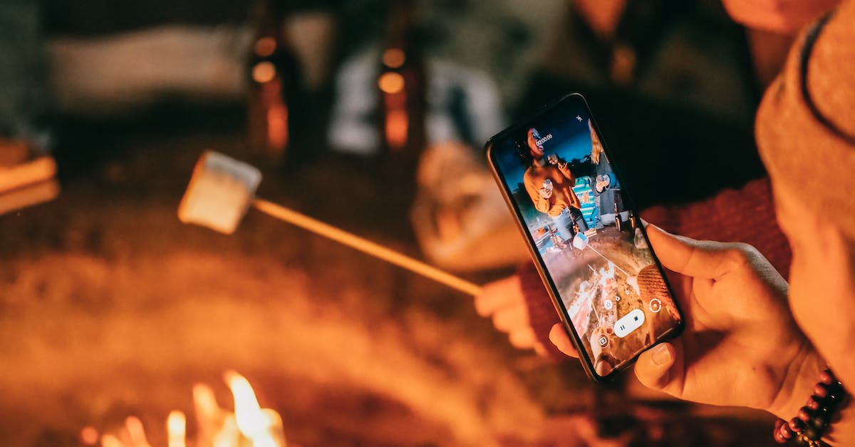 Taking camping food for Skiing in Val Thorens? - Man Recording on His Smartphone Women Roasting Marshmallow