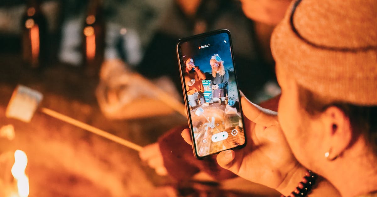 Taking camping food for Skiing in Val Thorens? - Man Recording on His Smartphone Women Roasting Marshmallow