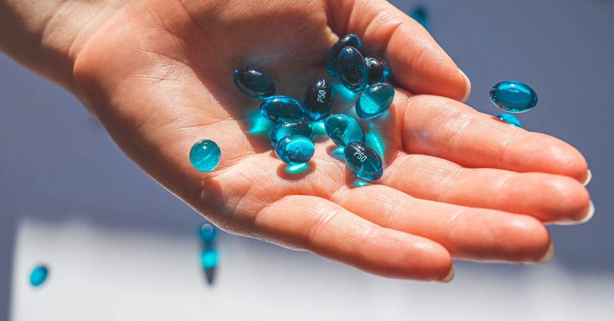 Taking personal prescription drugs to London? - Person Holding Blue Pills